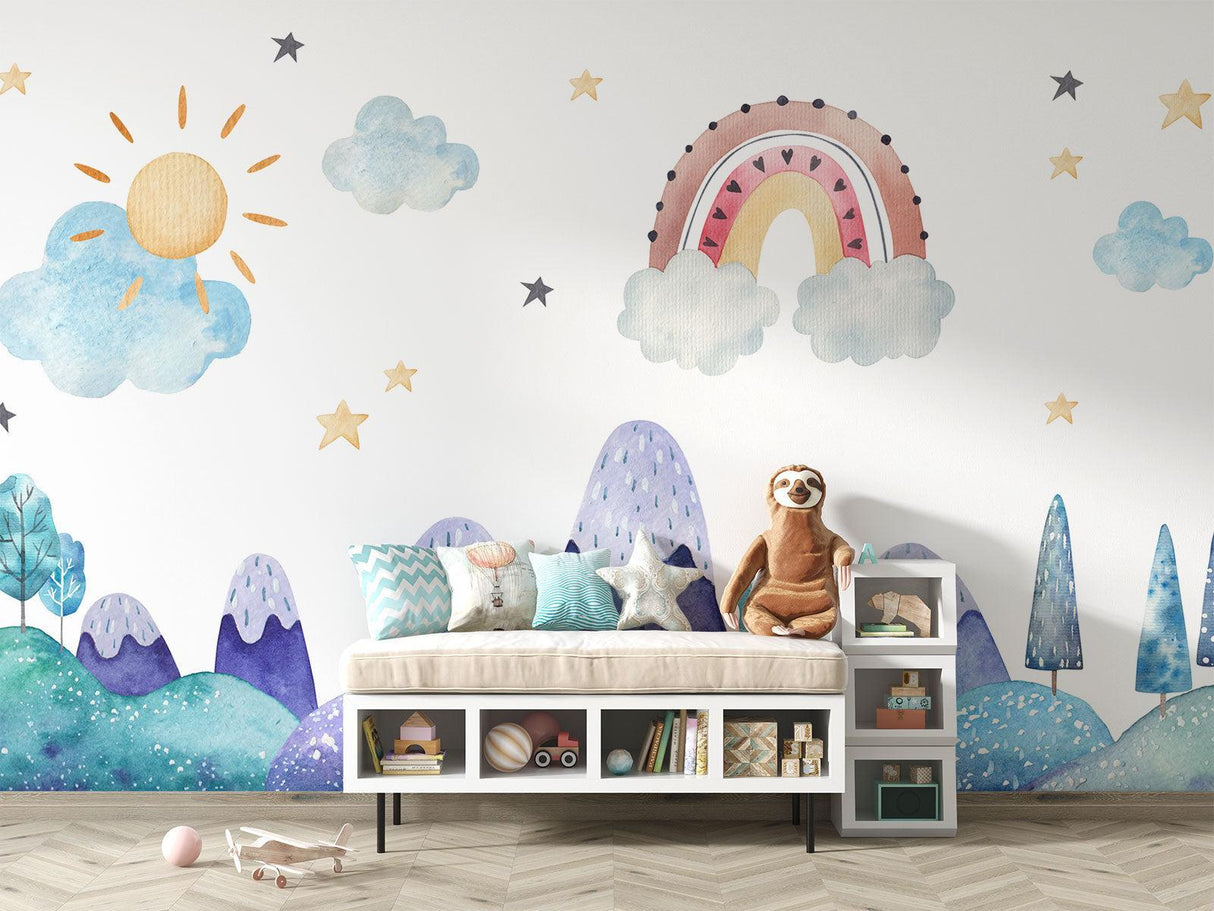 Mountain wall mural with rainbow and clouds brightens a baby's changing area