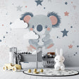 Koala nursery wallpaper in a modern baby room with white furniture