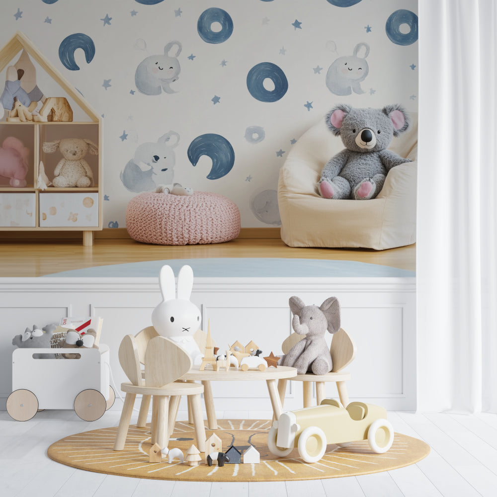 Koala moon phase wallpaper in a modern white nursery with wooden crib and rocking chair