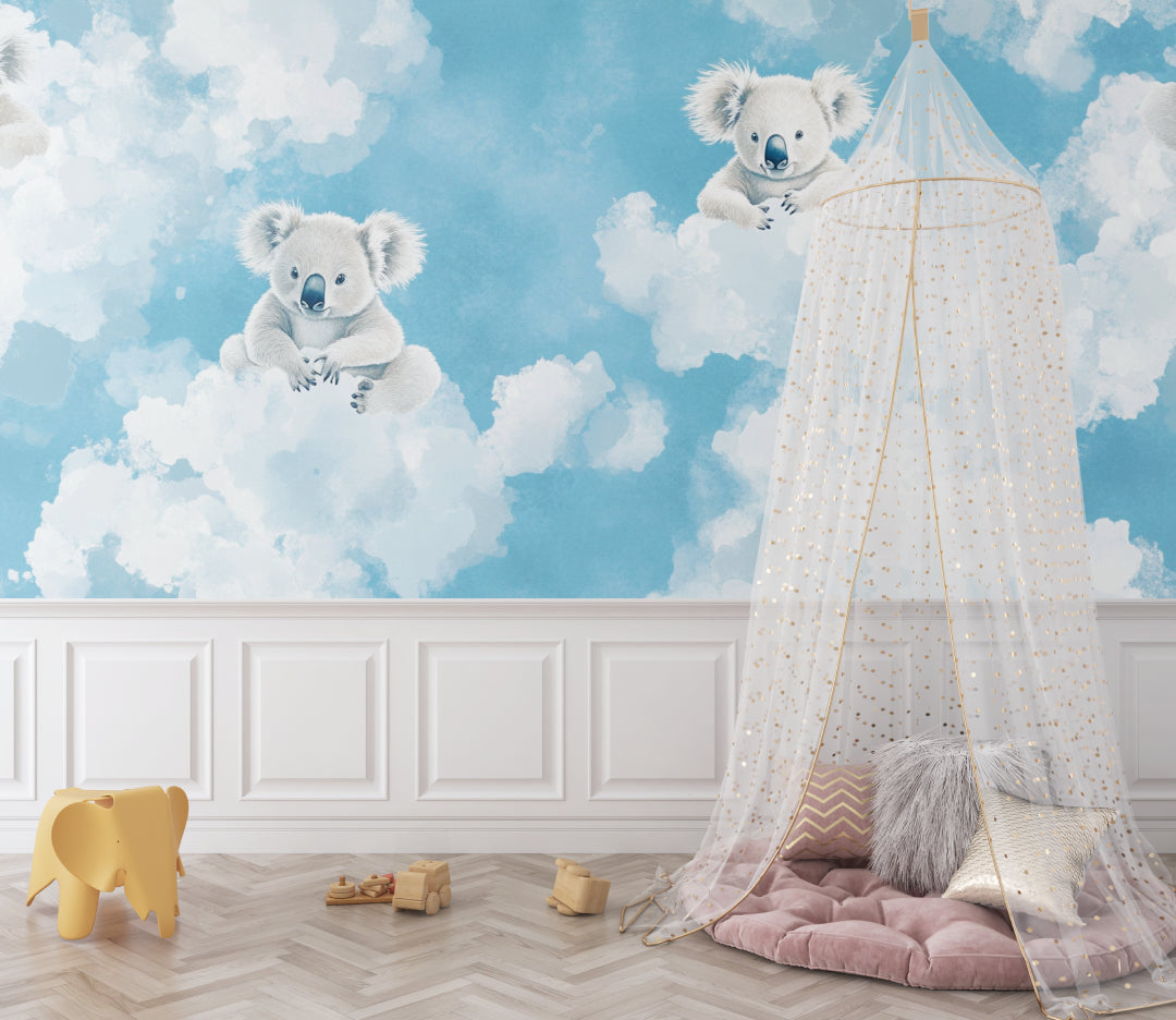 Koala wallpaper mural in a modern nursery with white furniture, showing floating koalas among clouds