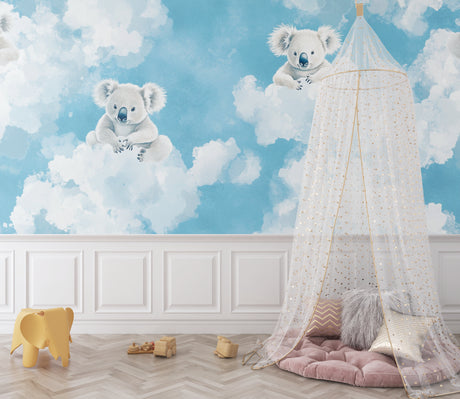 Koala wallpaper mural in a modern nursery with white furniture, showing floating koalas among clouds