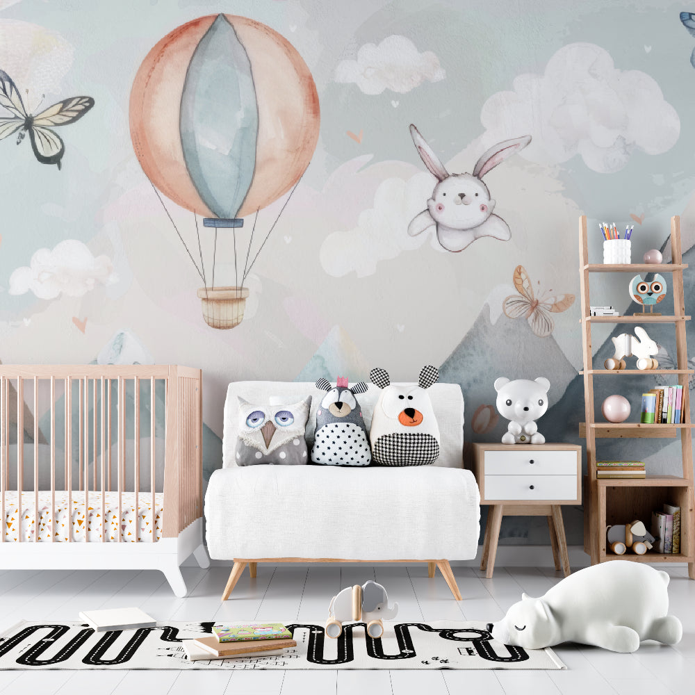 Hot air balloon nursery wallpaper in a bright modern nursery with white furniture