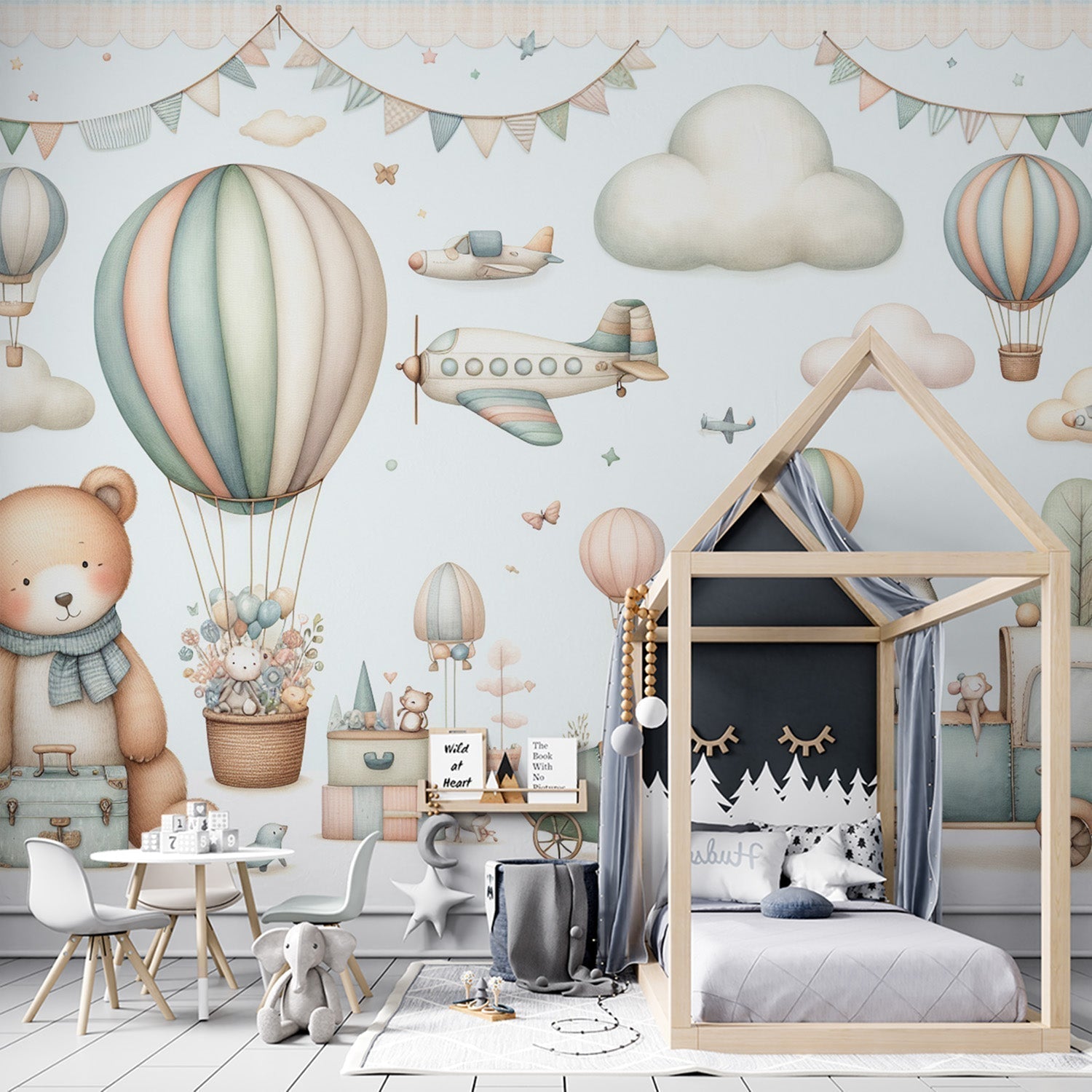 Hot air balloon nursery wallpaper in soft pastels shown in a bright children's bedroom with white furniture and natural light