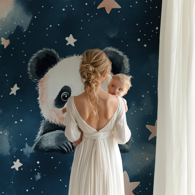 Baby room with panda and stars wallpaper alongside white furniture