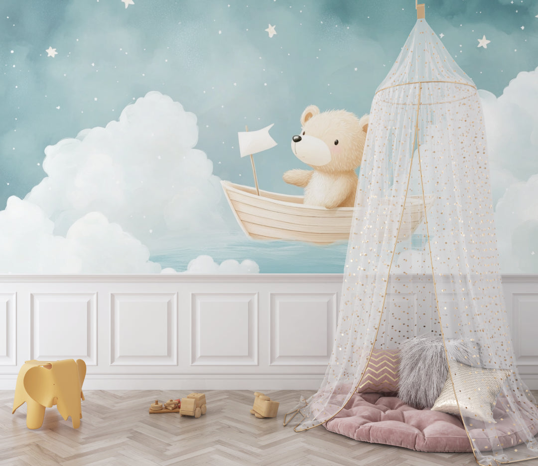 Teddy bear sailing mural in baby nursery with rocking chair and shelves