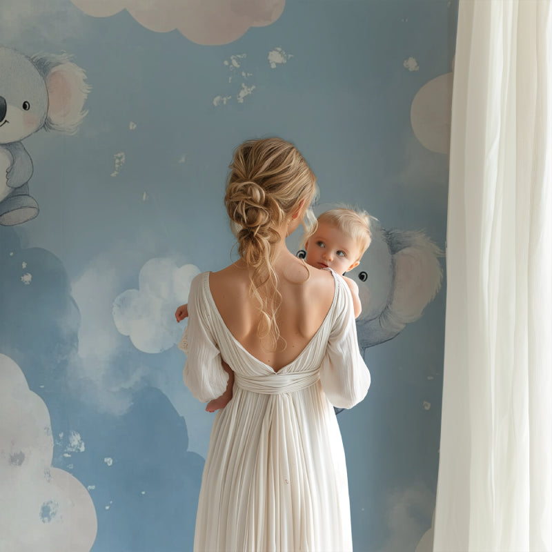 Nursery wall mural featuring koalas installed behind a white crib