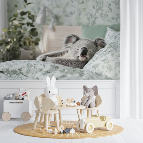 Koala nursery wallpaper styled in a modern baby room with white furniture and natural light