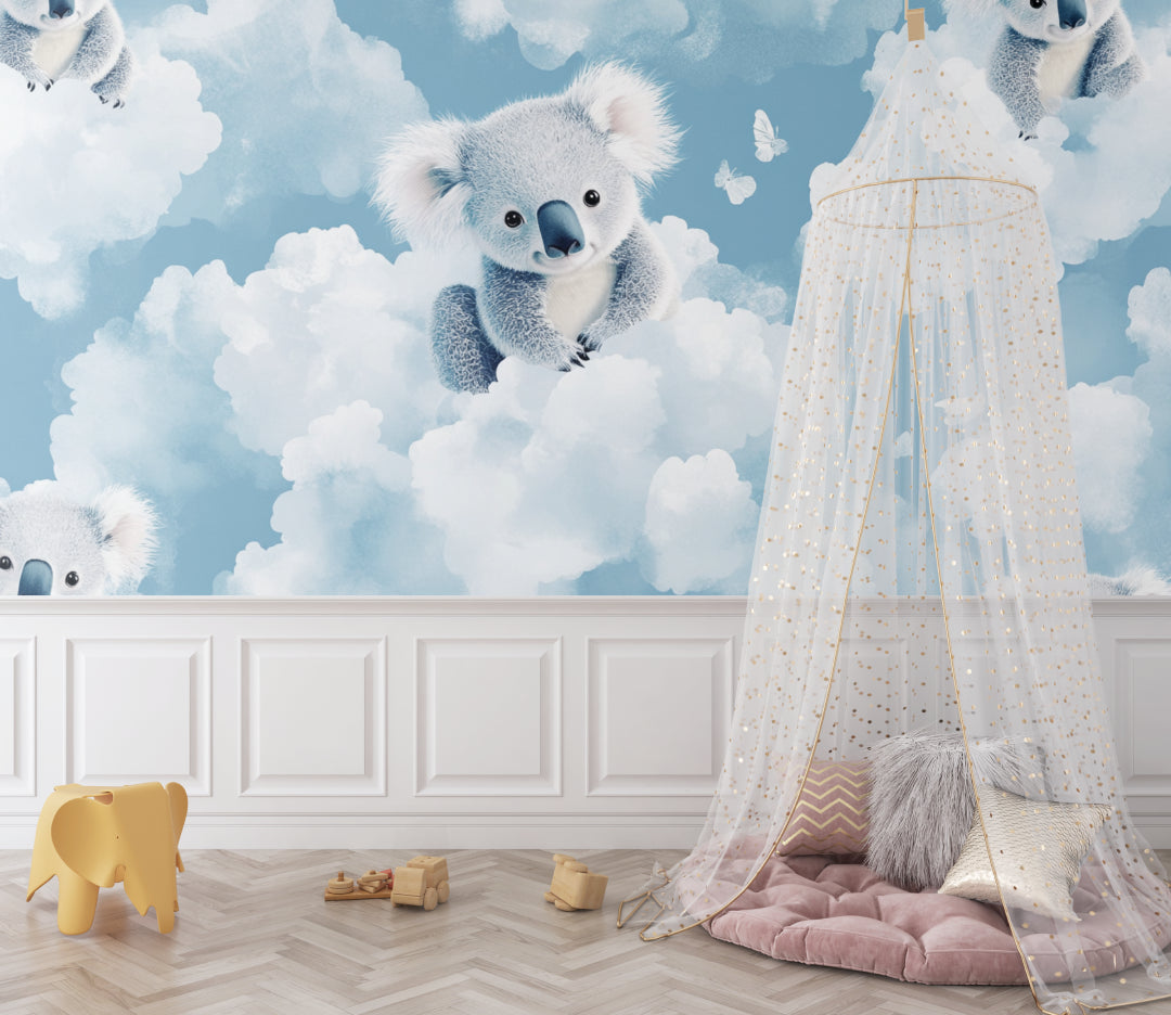 Koala cloud wallpaper in a bright nursery with white furniture showing the calming effect of the design