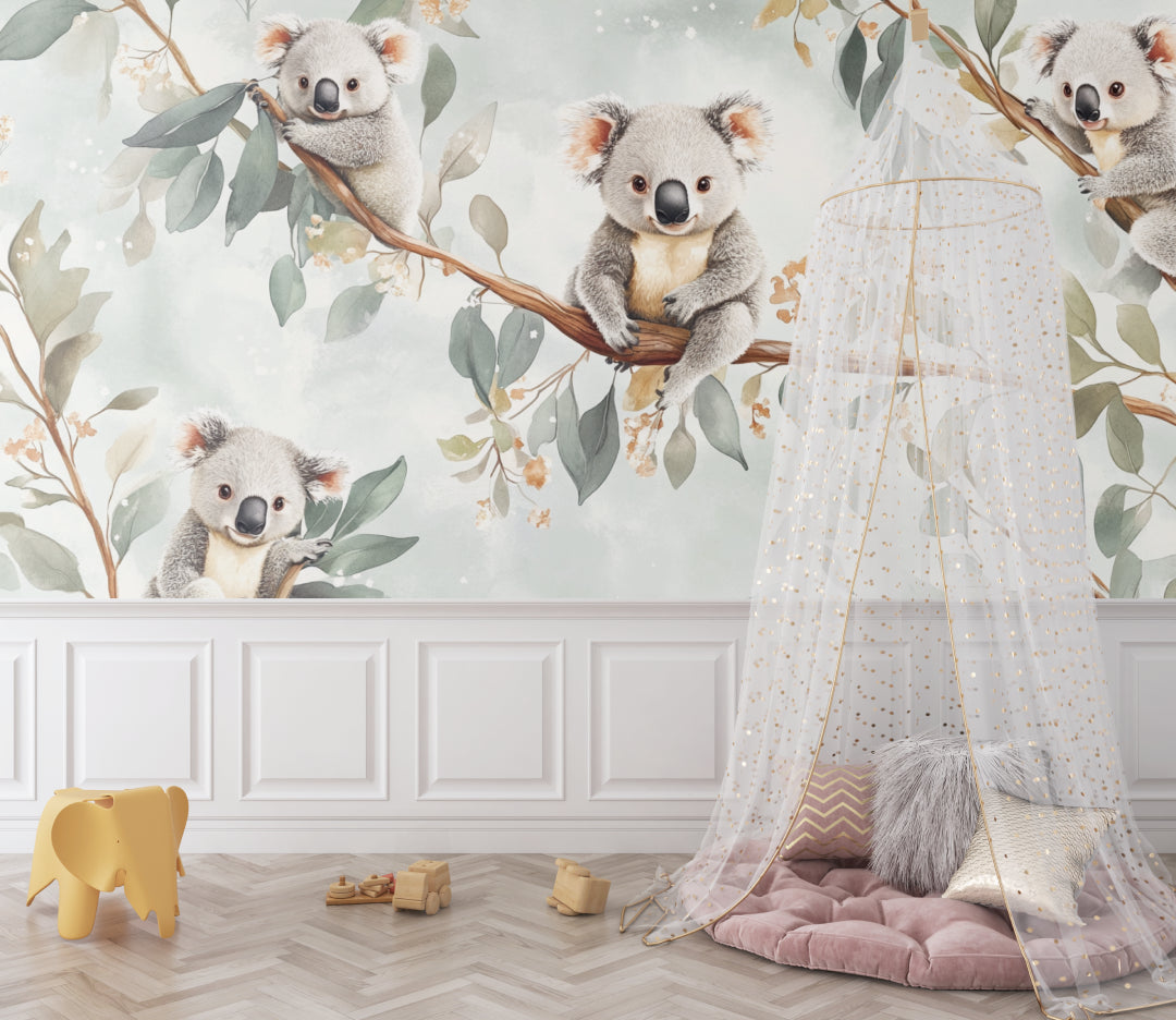 Koala wallpaper mural styled in a bright nursery with white furniture and natural decor elements