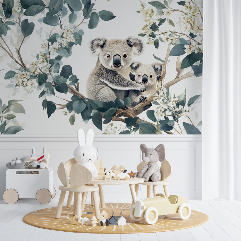 Nature-themed koala mural wallpaper in a baby's room with white furniture