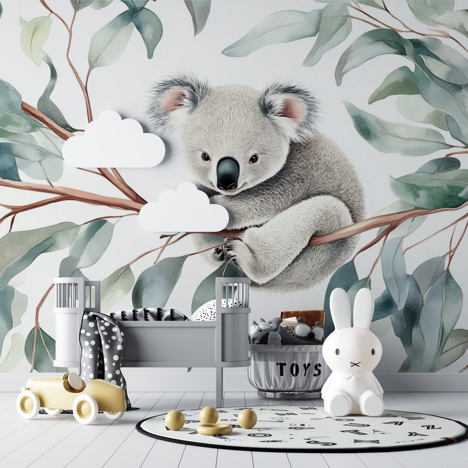 Koala wallpaper mural in a bright nursery with white furniture, showing the full wall design
