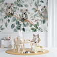 Koala wallpaper mural creating a peaceful atmosphere in a modern nursery with white furniture