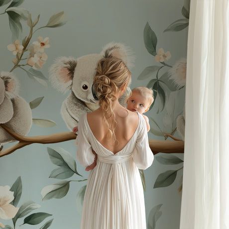 Koala nursery wallpaper in a peaceful baby room with soft lighting and natural wood furniture
