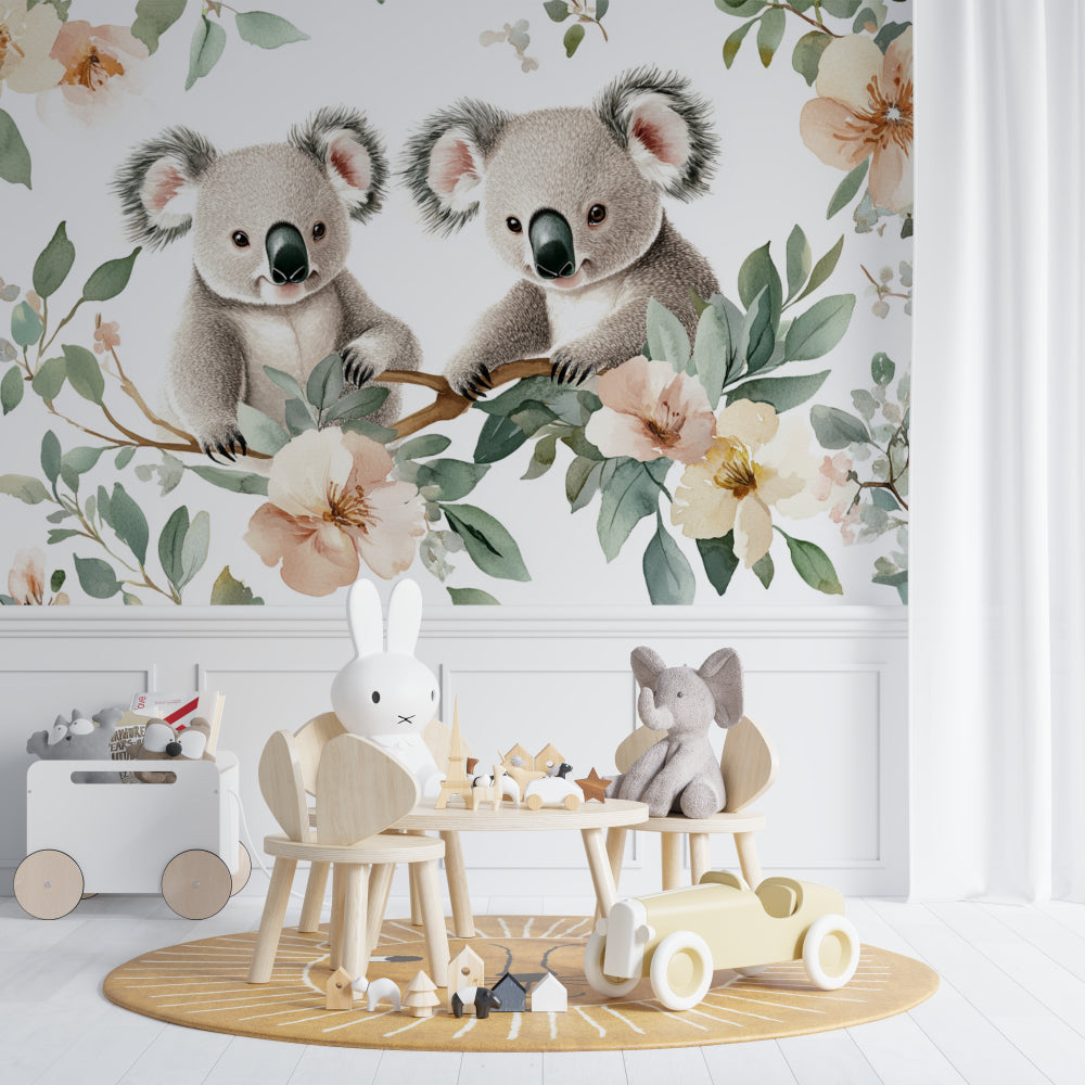 Nursery koala wallpaper styled with minimalist white furniture and green accents