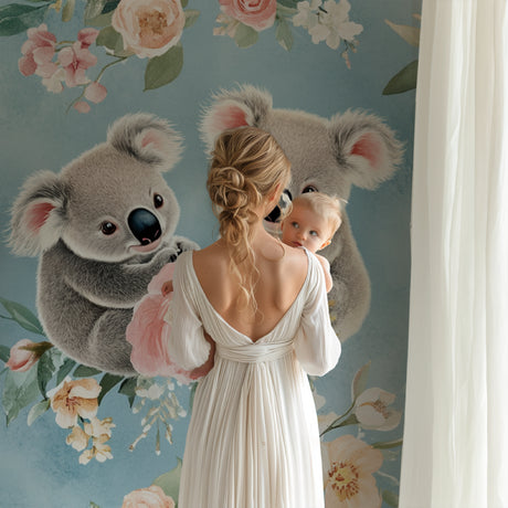 Koala nursery wallpaper in a baby girl's room with pink accents and gentle lighting