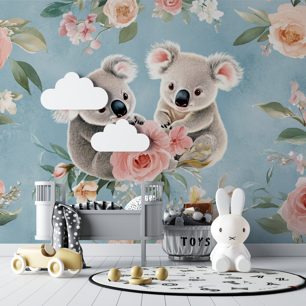 Nursery koala wallpaper styled with natural wood crib and pink accessories