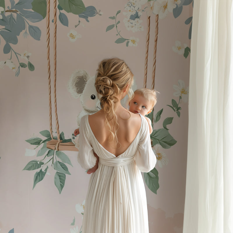 Nursery featuring koala wallpaper design with rocking chair and mobile