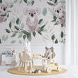 Koala nursery wallpaper creating a peaceful atmosphere in a modern white nursery with natural wood furniture
