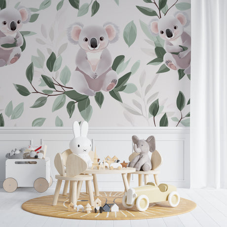 Koala nursery wallpaper creating a peaceful atmosphere in a modern white nursery with natural wood furniture