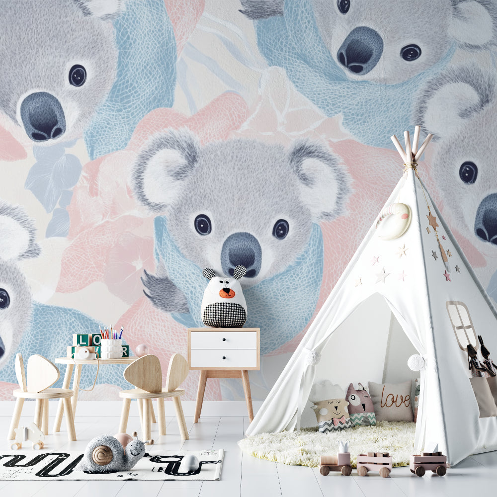 Pink and blue koala wallpaper in baby girl's room with white furniture