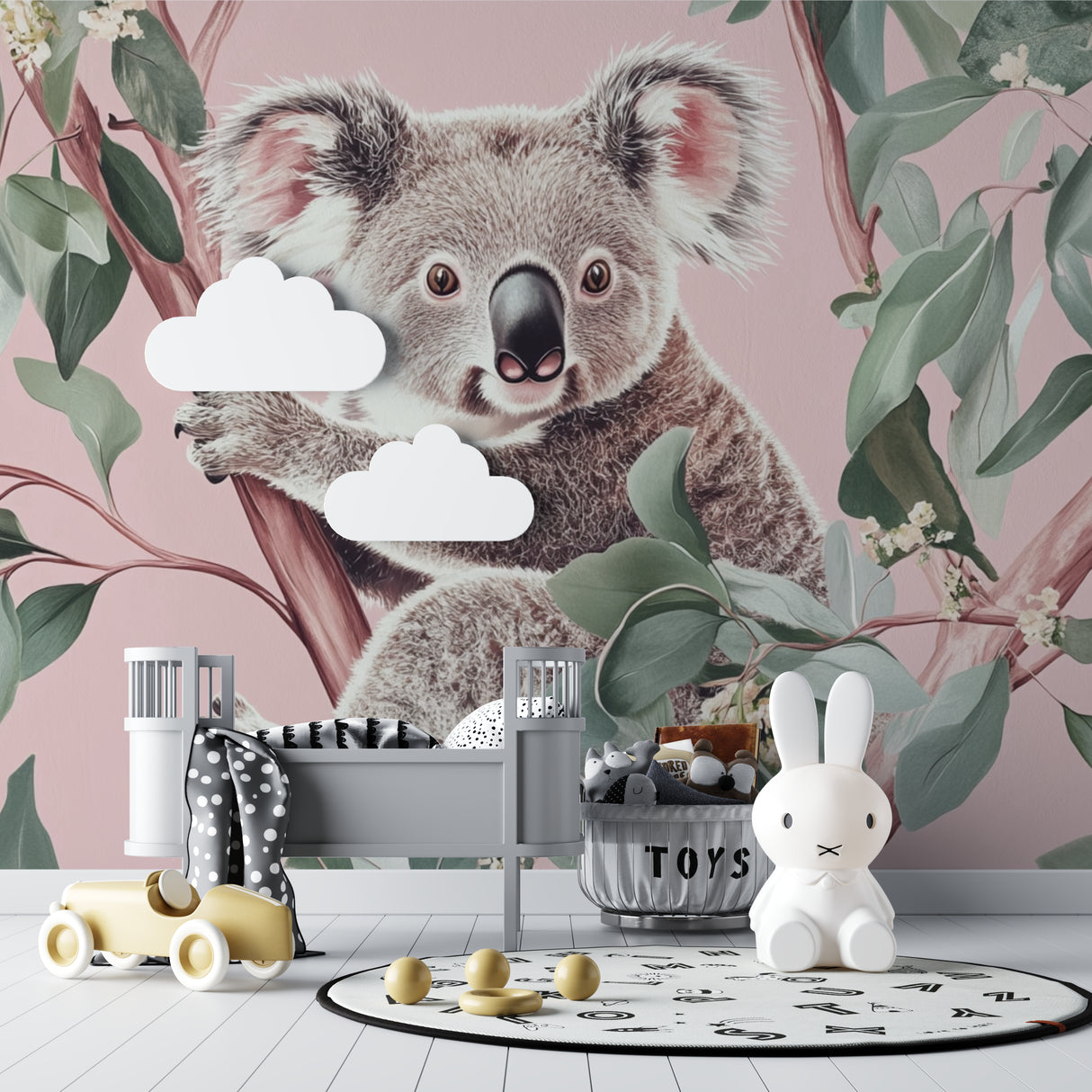 Koala wallpaper mural in a soft pink nursery with white furniture and natural decor