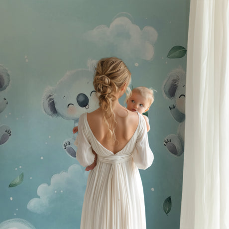 Koala nursery wallpaper creating a peaceful atmosphere in a modern baby room with white furniture