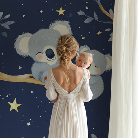 Koala nursery wallpaper creating a peaceful atmosphere in a modern white nursery with wooden furniture