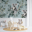 Koala wallpaper mural in a bright nursery with white furniture showing peaceful eucalyptus design