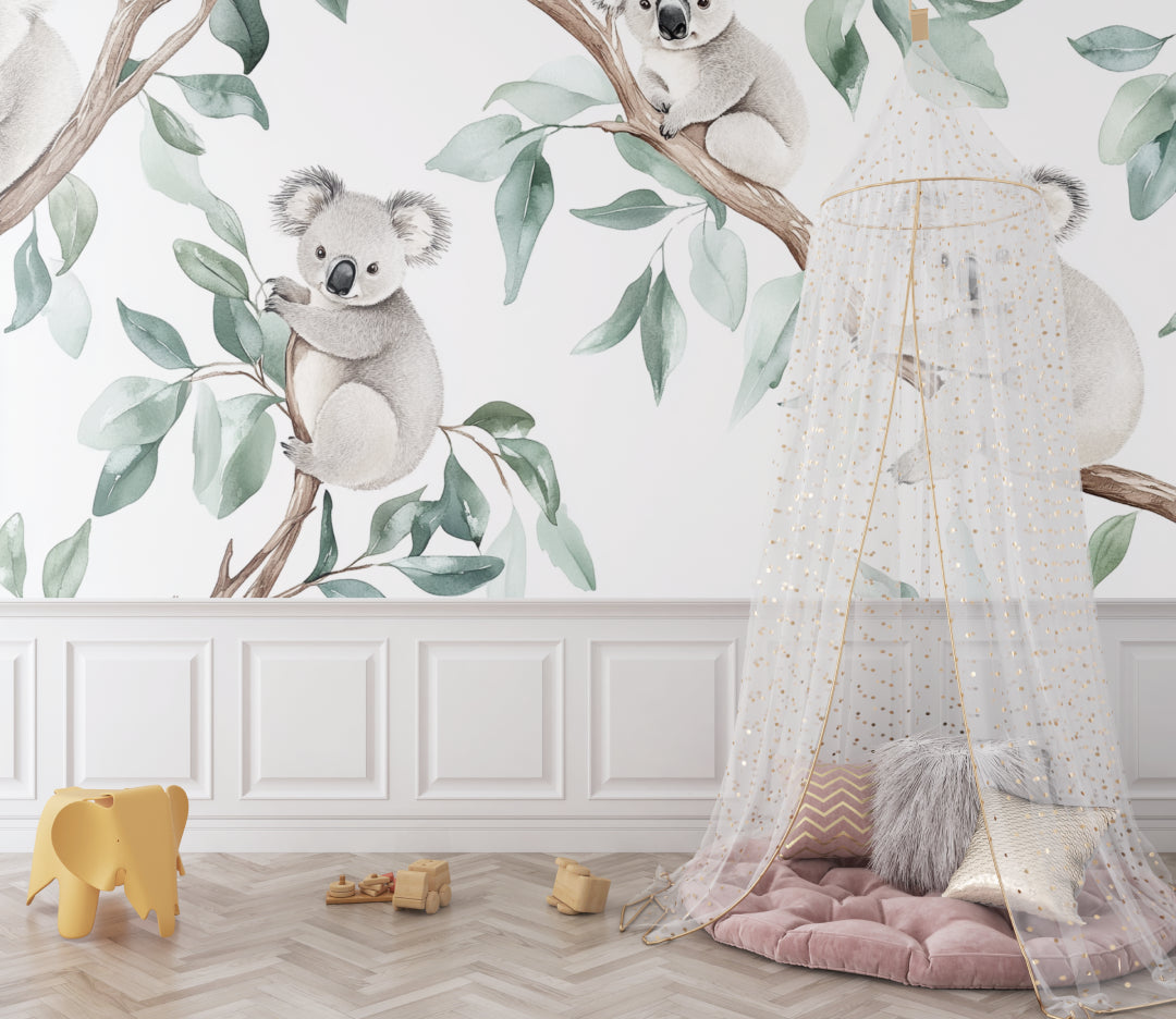 Koala wallpaper mural in a bright nursery with white furniture and natural accents