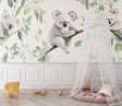 Koala wallpaper mural creating a peaceful atmosphere in a modern nursery with white furniture