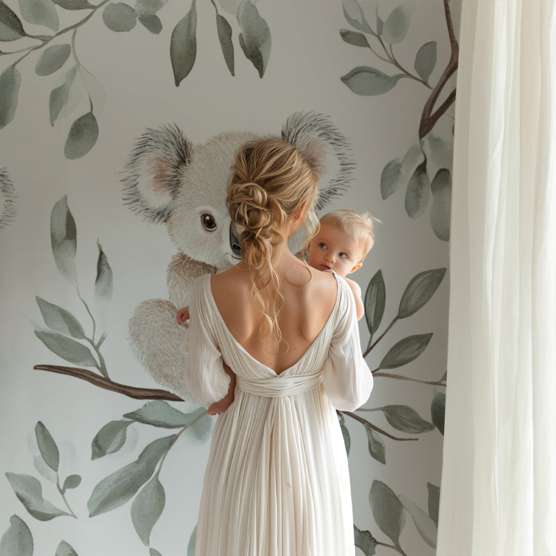 Nursery koala mural styled with natural wood elements and soft textiles