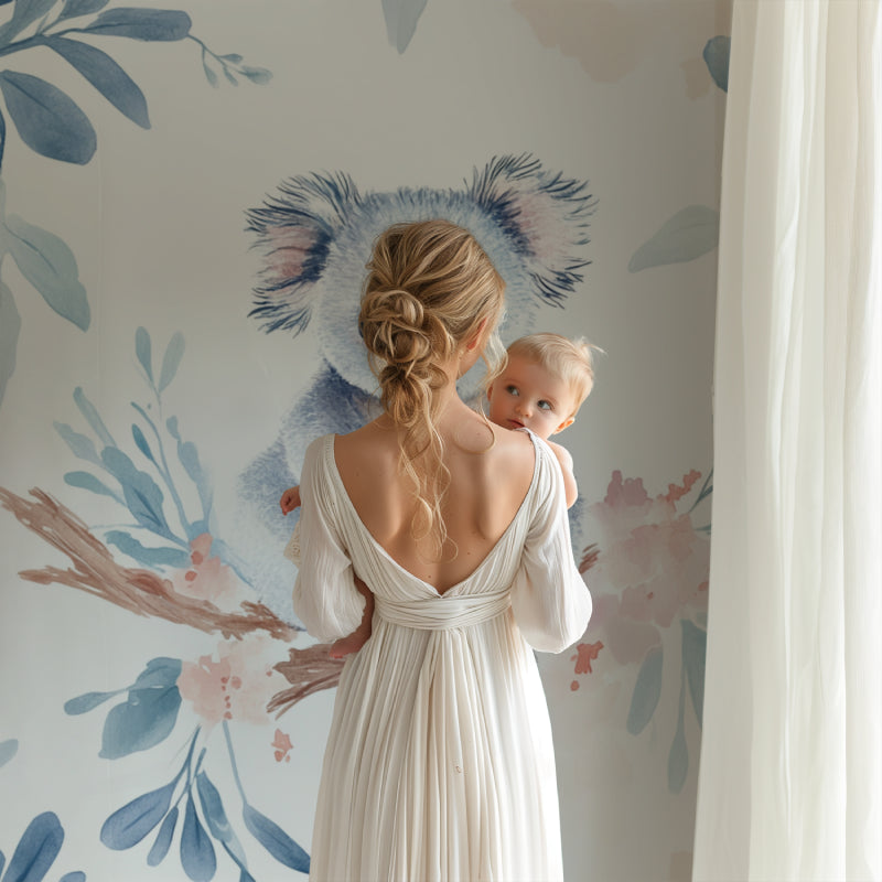 Koala wallpaper mural creating a peaceful atmosphere in a modern nursery with white furniture