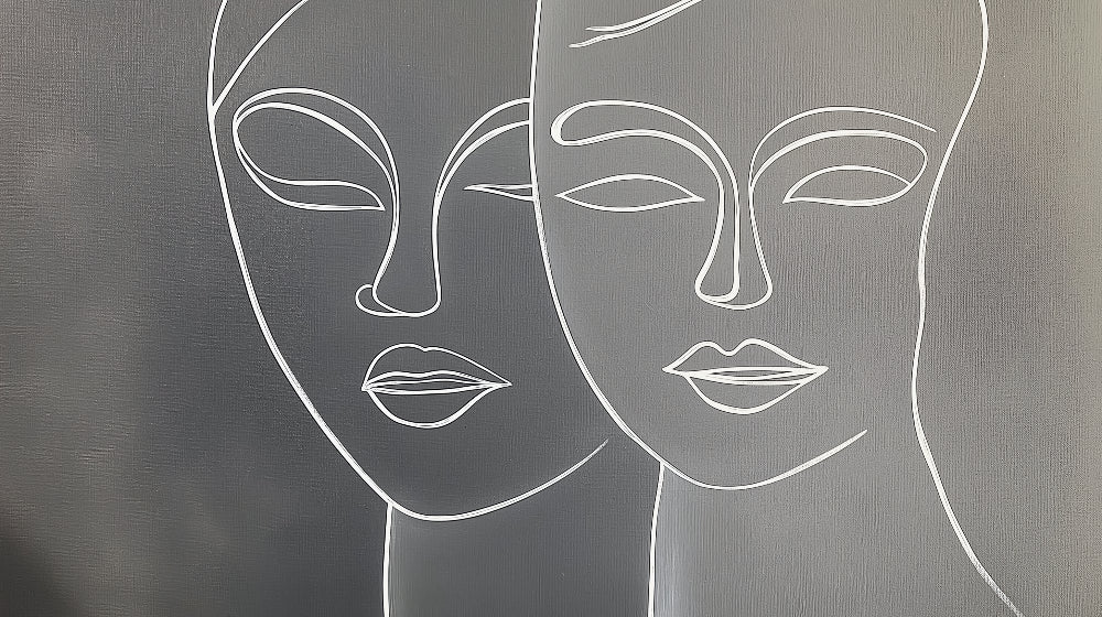 Line art face wallpaper creating a modern statement wall in a minimalist living room with grey sofa and natural light