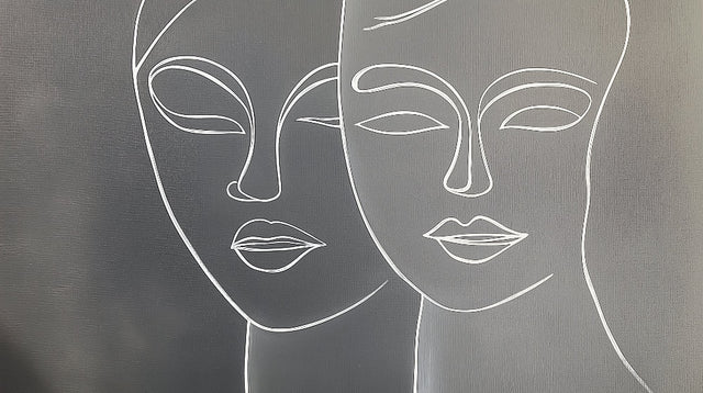 Line art face wallpaper creating a modern statement wall in a minimalist living room with grey sofa and natural light