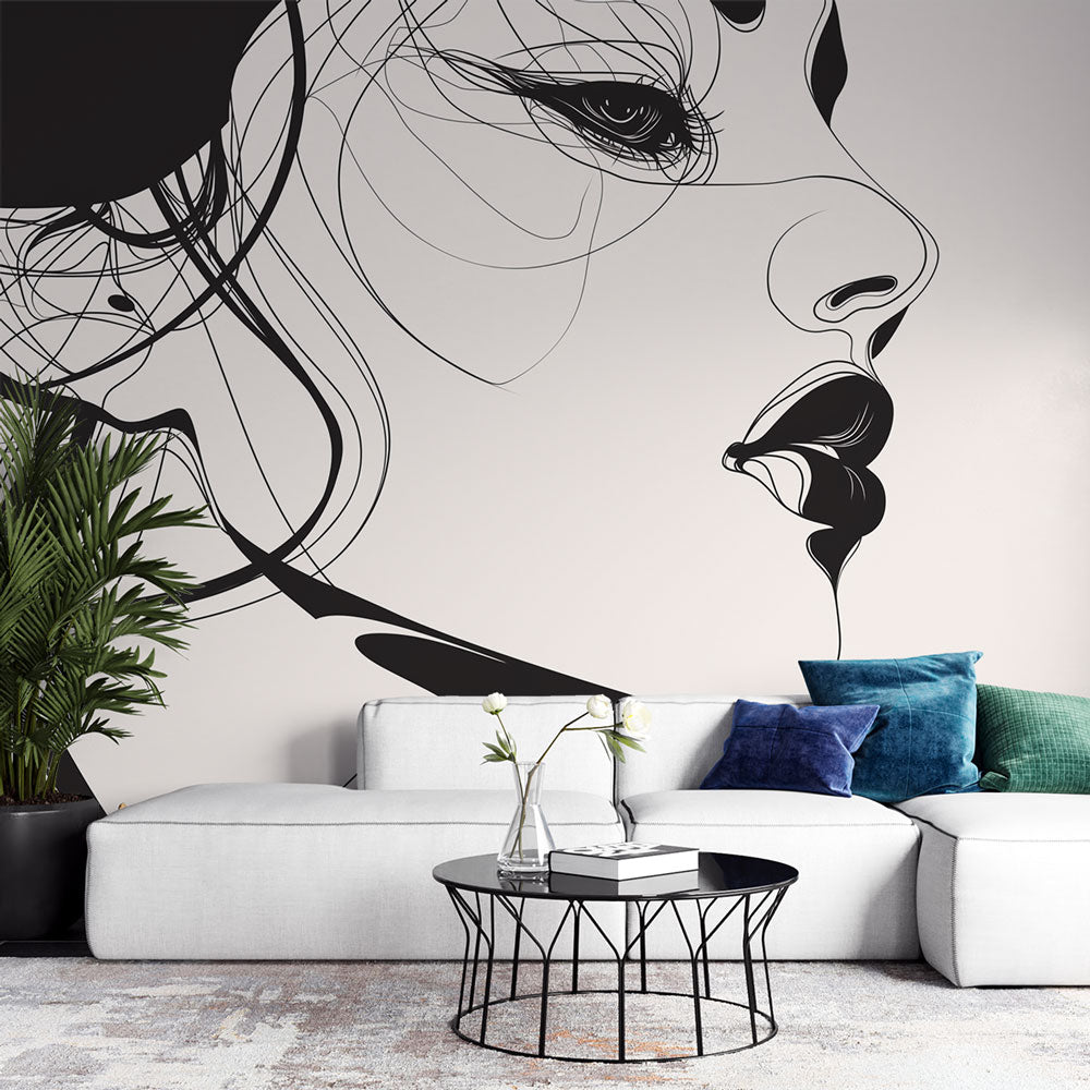 Line art portrait wallpaper creating dramatic focus in a modern living room with minimal furniture and natural light