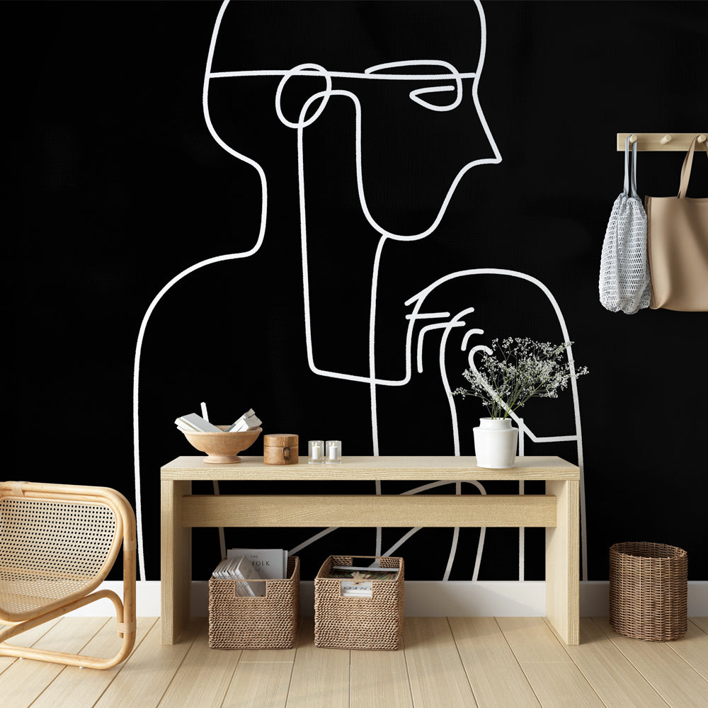 Line art face wallpaper creating dramatic contrast in a modern minimalist living room setting with white furniture