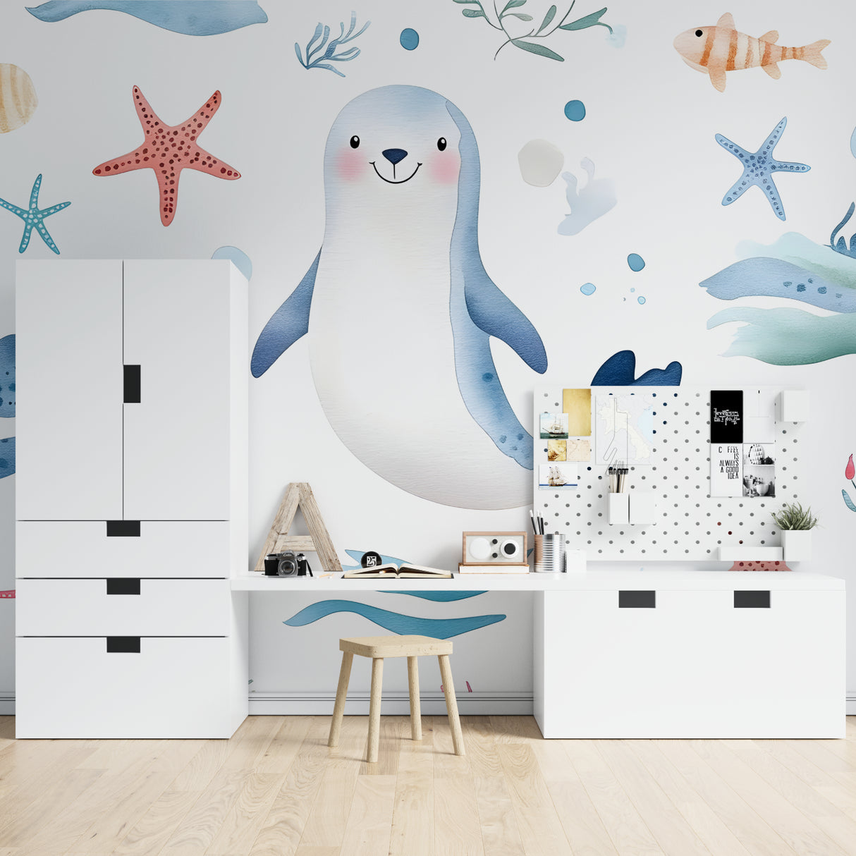 Marine animals wallpaper in bright nursery with white furniture showing playful seal and starfish design