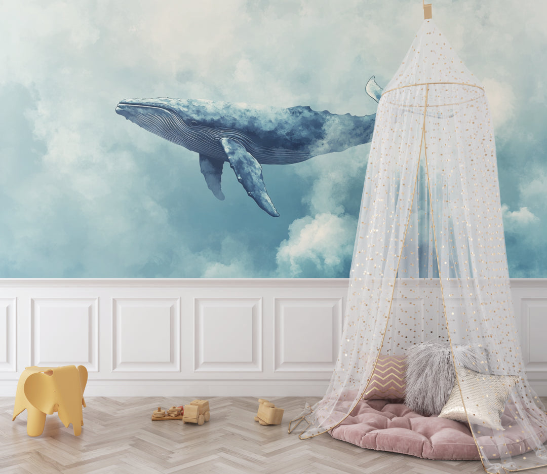 Whale wall mural in kid's bedroom with blue accents and playful decor