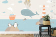 Marine animals wallpaper in a bright kids bedroom, showing playful whale and penguins design above a cozy reading nook