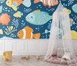 Marine fish wallpaper brightening a modern kids' bedroom with cheerful orange clownfish and blue accents