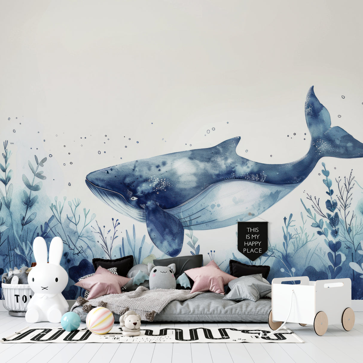 Whale wall mural in nursery showing soft watercolor marine design