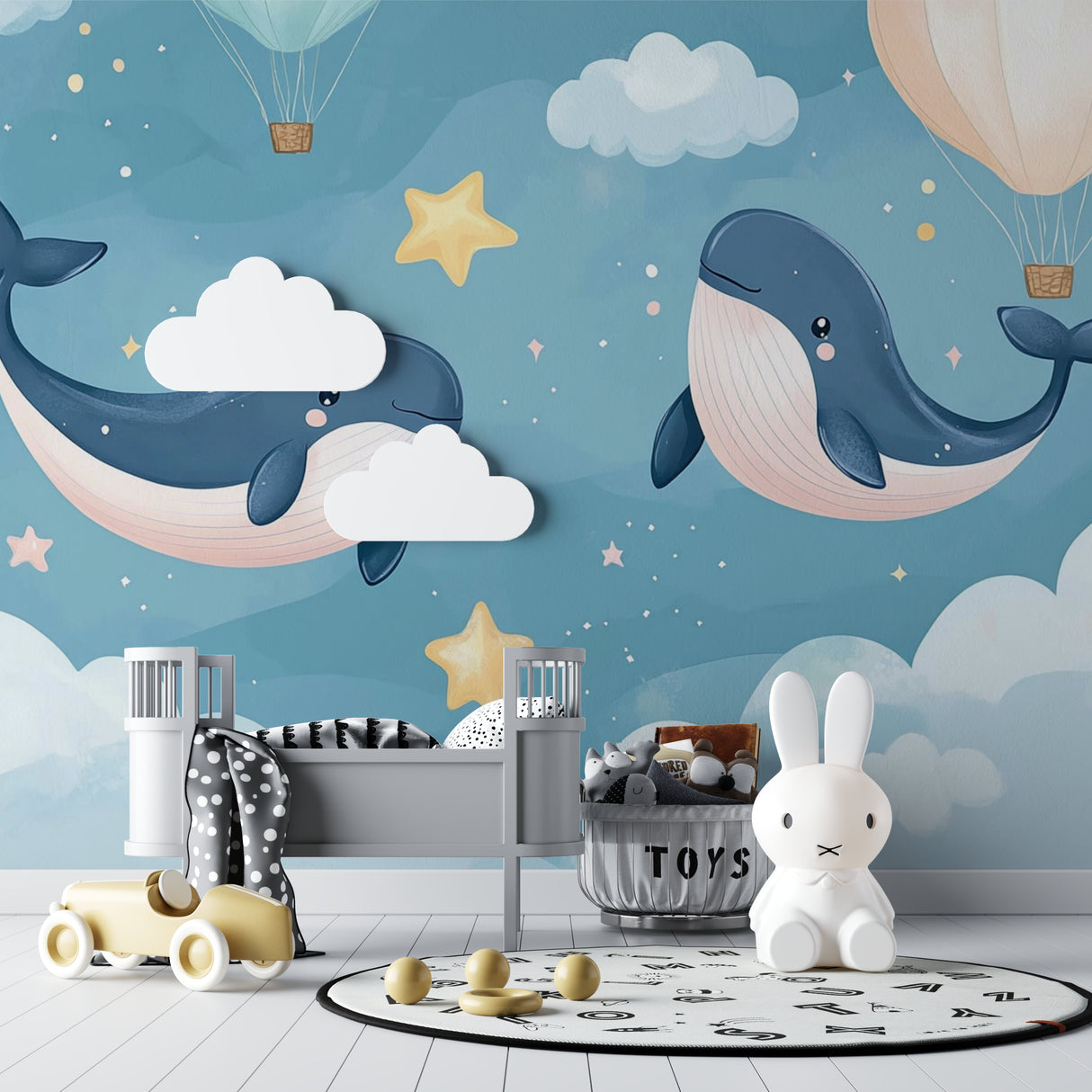 Dreamy whale wallpaper featured in a baby's room with white furniture