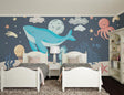 Marine animals wallpaper creating a magical atmosphere in a cozy nursery with soft blue lighting