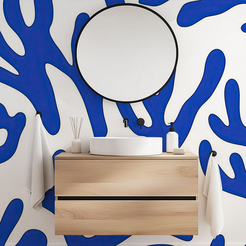 Modern living room with blue coral wallpaper creating a calm, coastal atmosphere against white furniture