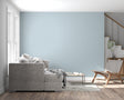 Powder blue minimalist wallpaper in modern living room with natural light streaming through windows
