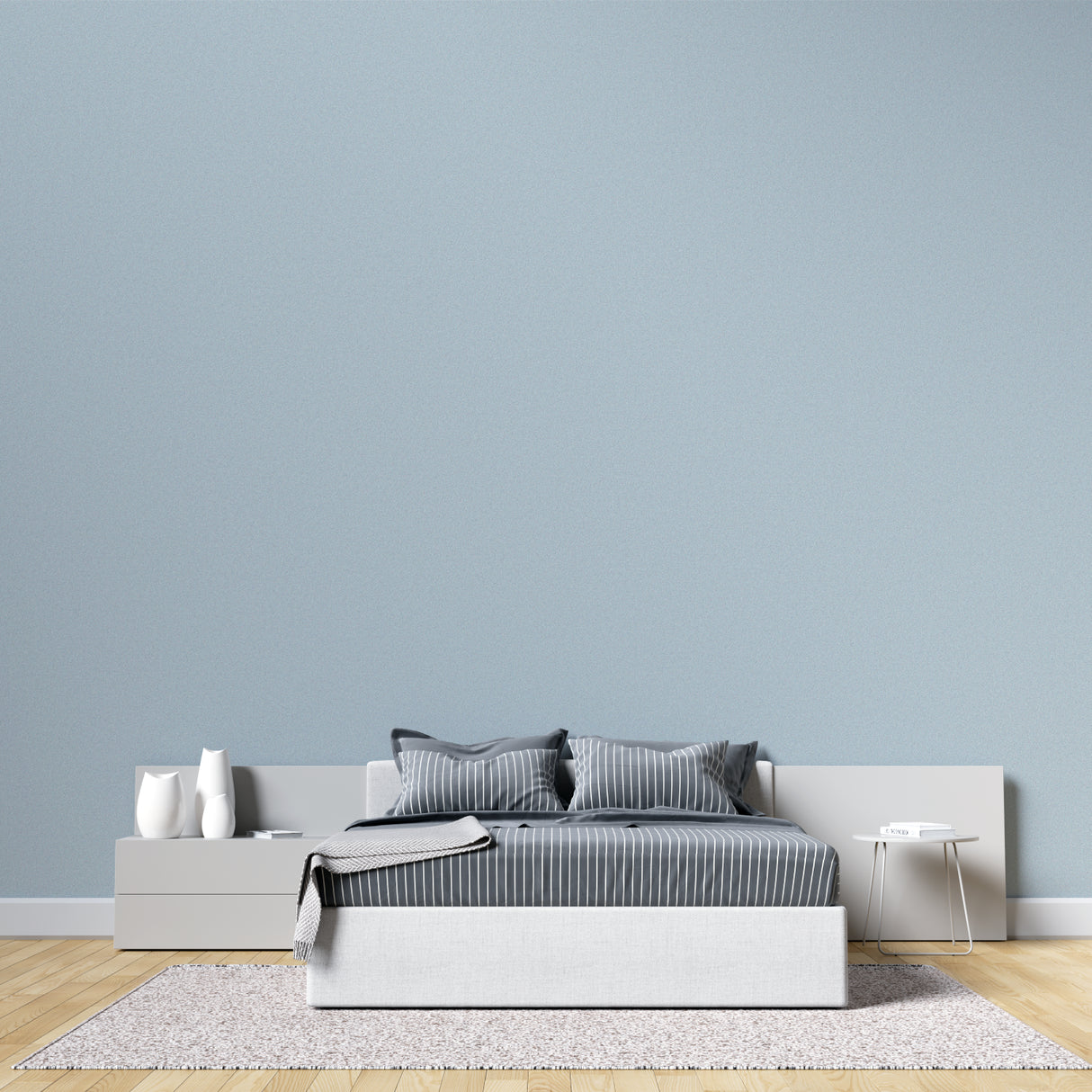 Minimalist dining room with soft blue wallpaper creating airy atmosphere