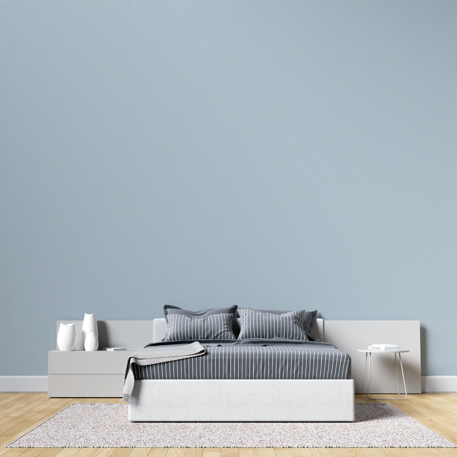 Minimalist dining room with soft blue wallpaper creating airy atmosphere