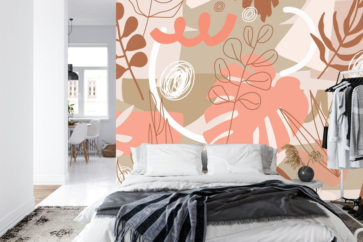 Home office space with contemporary Monstera leaf wall mural in warm coral tones