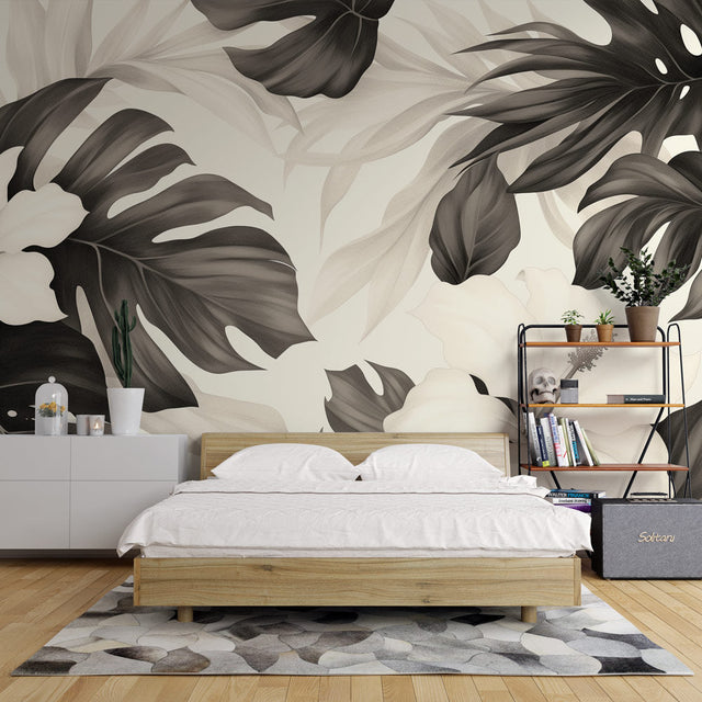 Black and white Monstera leaf wallpaper creating a stunning focal point in a modern living room with natural light