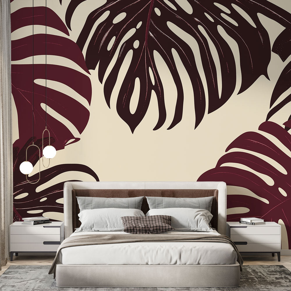 Burgundy Monstera leaf wallpaper creating a dramatic accent wall in a modern living room with minimal furniture